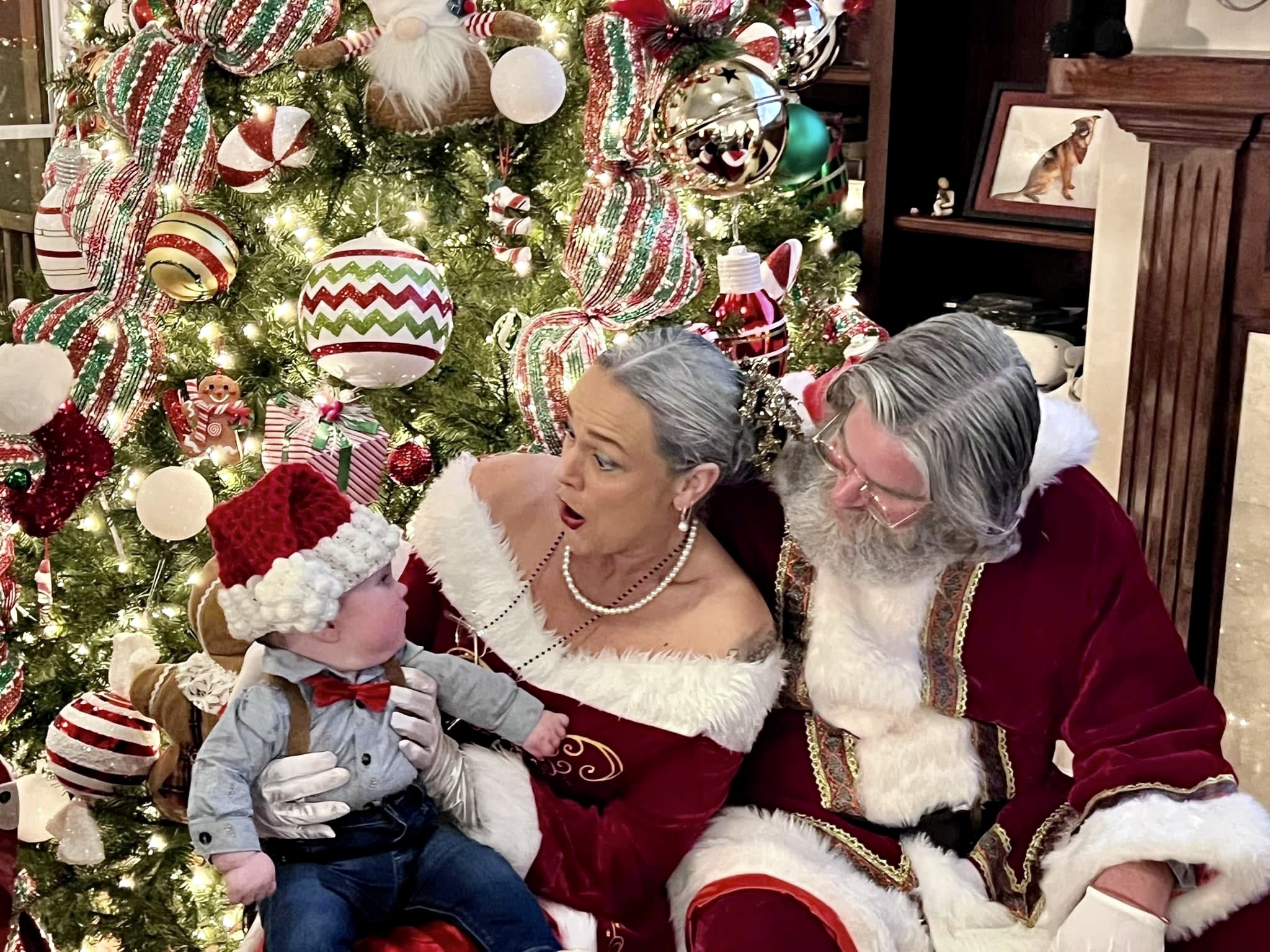 Santa and Mrs. Claus with a child